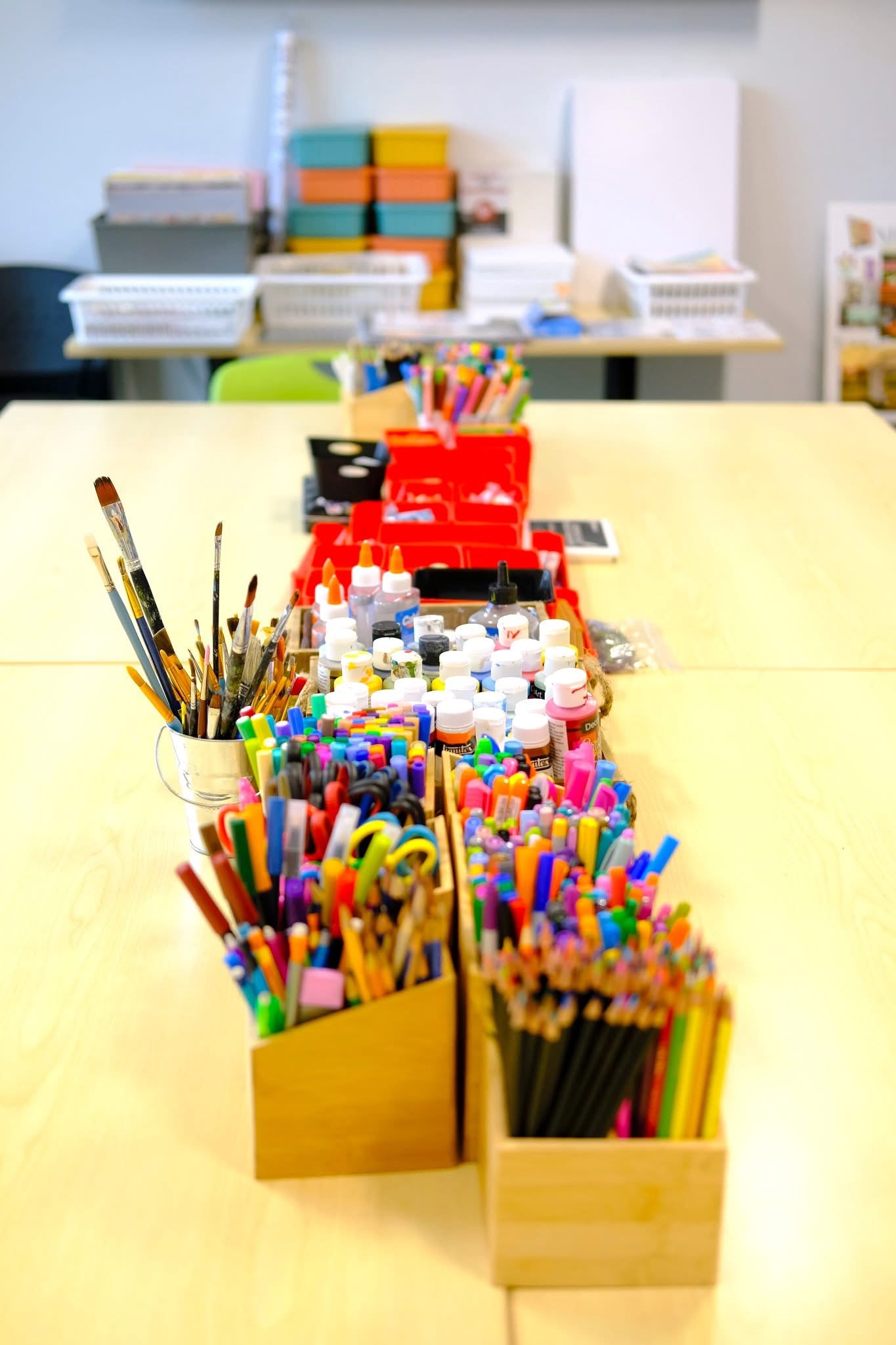 Assorted stationery items including pencils, markers, and erasers on a desk.